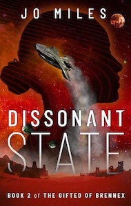 The cover is red with what looks like an desert landscape at the bottom of the cover with a few buildings around, with a moon and a star filled sky above it. In the background there is the black profile of a head over the sky looking towards the right. There is a space ship flying up and to the left with a trail of white light coming from the bottom. 